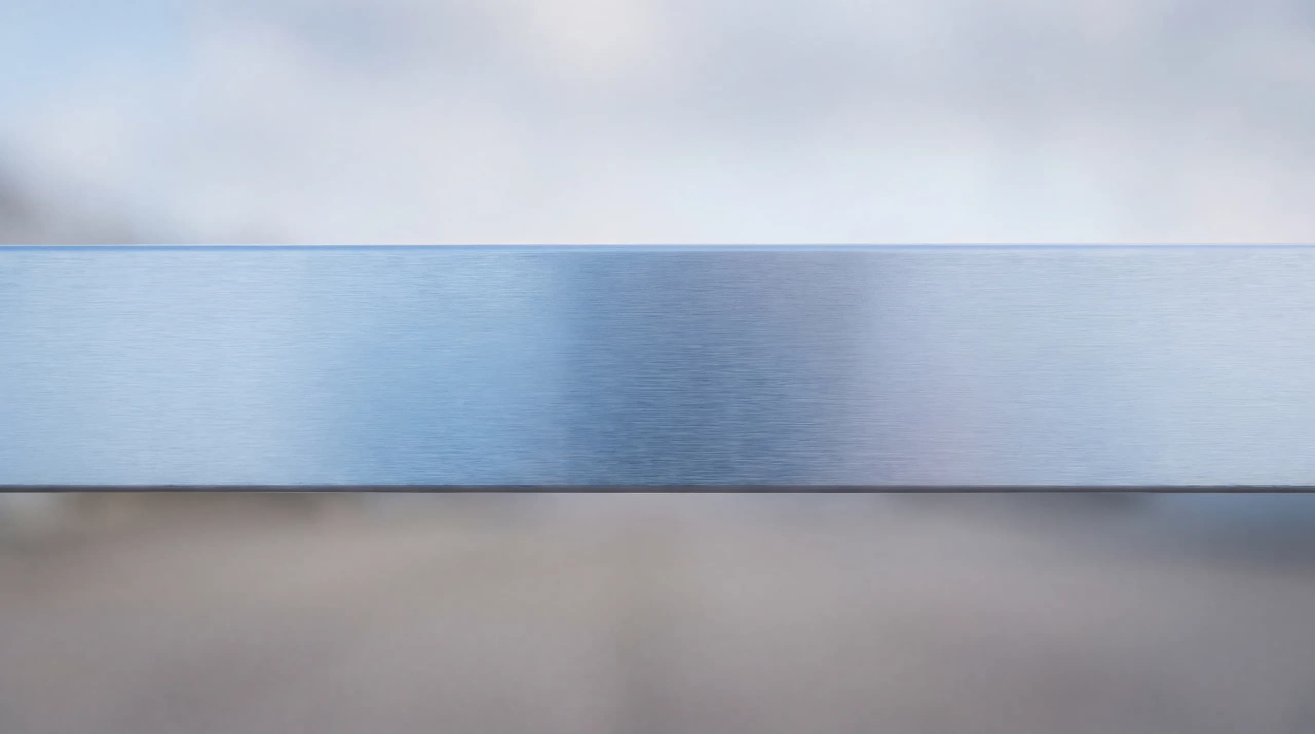 Brushed aluminium with a calm cool-blue sheen