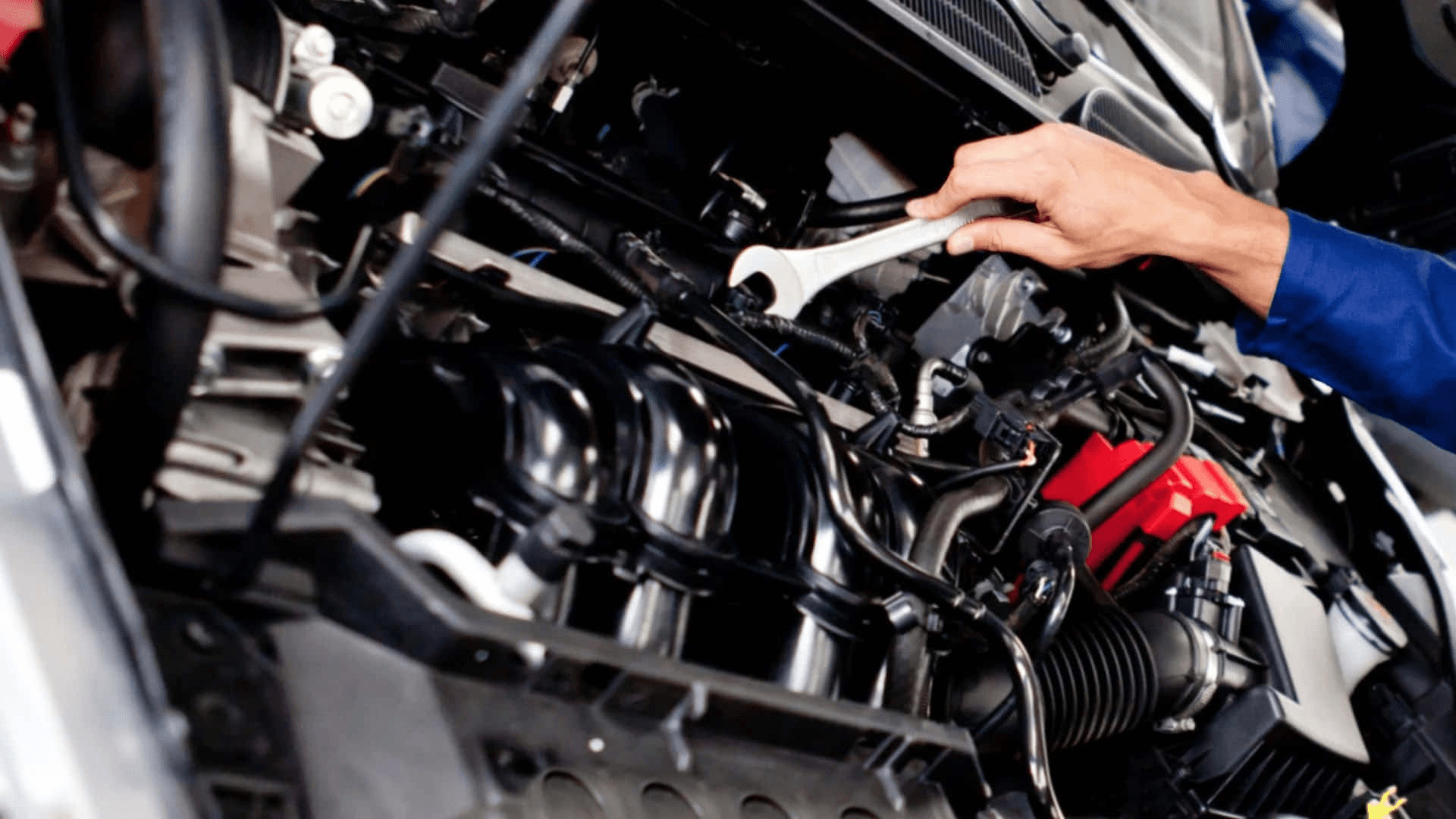 Car mechanic working on engine